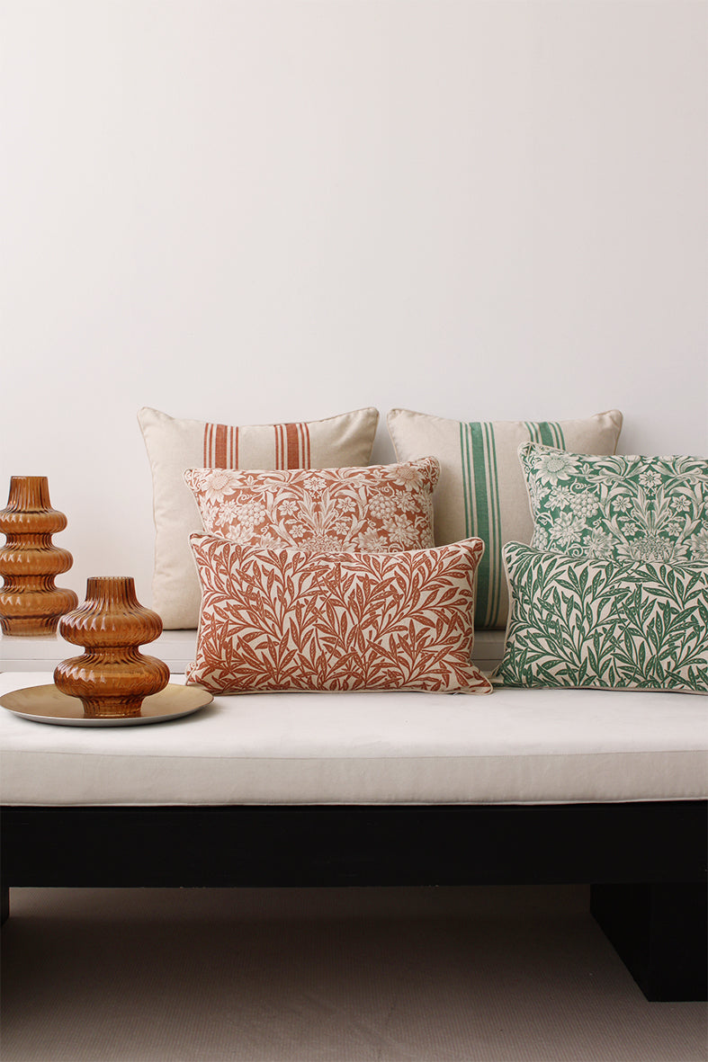 Linen & Grace Raya Red cushion with textured fabric and decorative stitching on beige background.