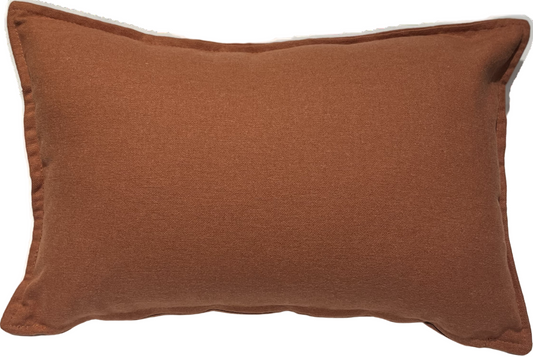 A rectangular throw pillow with a solid Terracotta color. 45x30cm ; a touch of nature