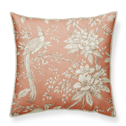 A square-shaped cushion with a floral pattern featuring a pheasant and various plants, in a color palette that includes old pink and white.