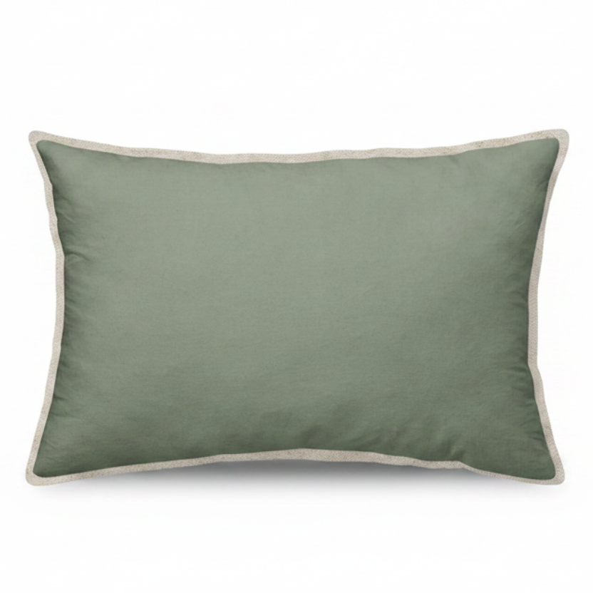 Green cushion with beige trim on a white background