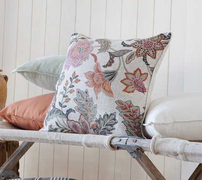 Decorative cushions on a bench with rustic vases against a white paneled wall
