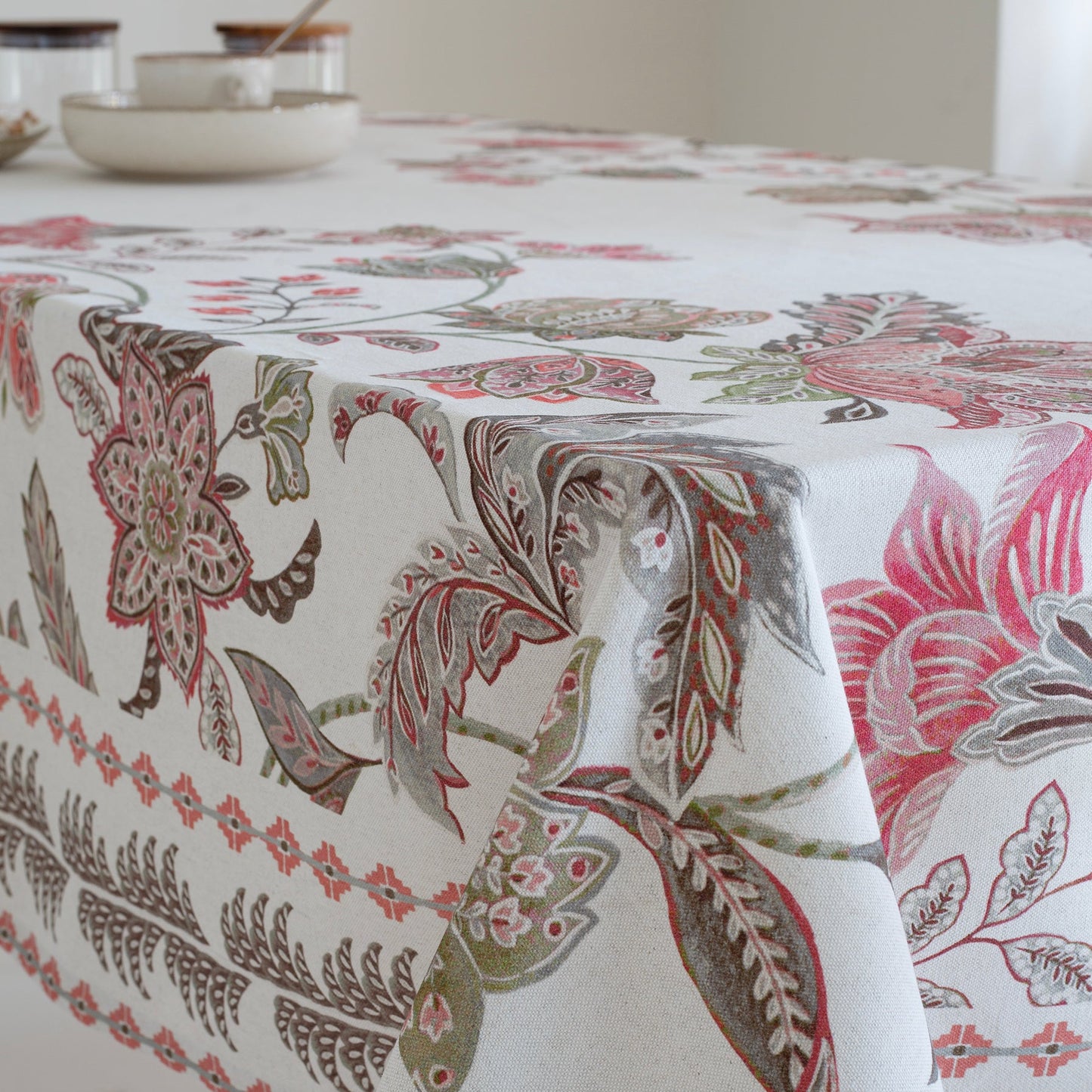 Floral patterned tablecloth on a table with a neutral background