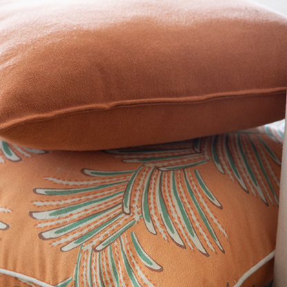 Close-up of a cushion with leaf pattern on a textured surface