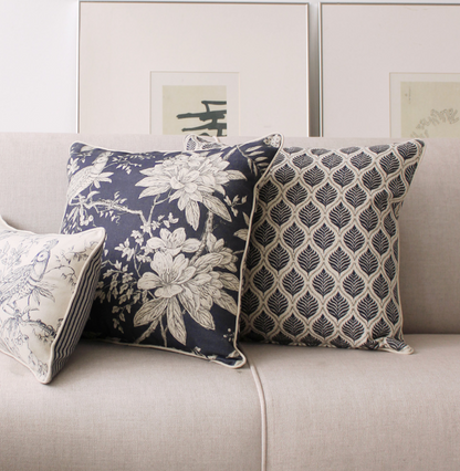 Decorative blue linen pillows with floral and geometric patterns with piping in linen vintage design
