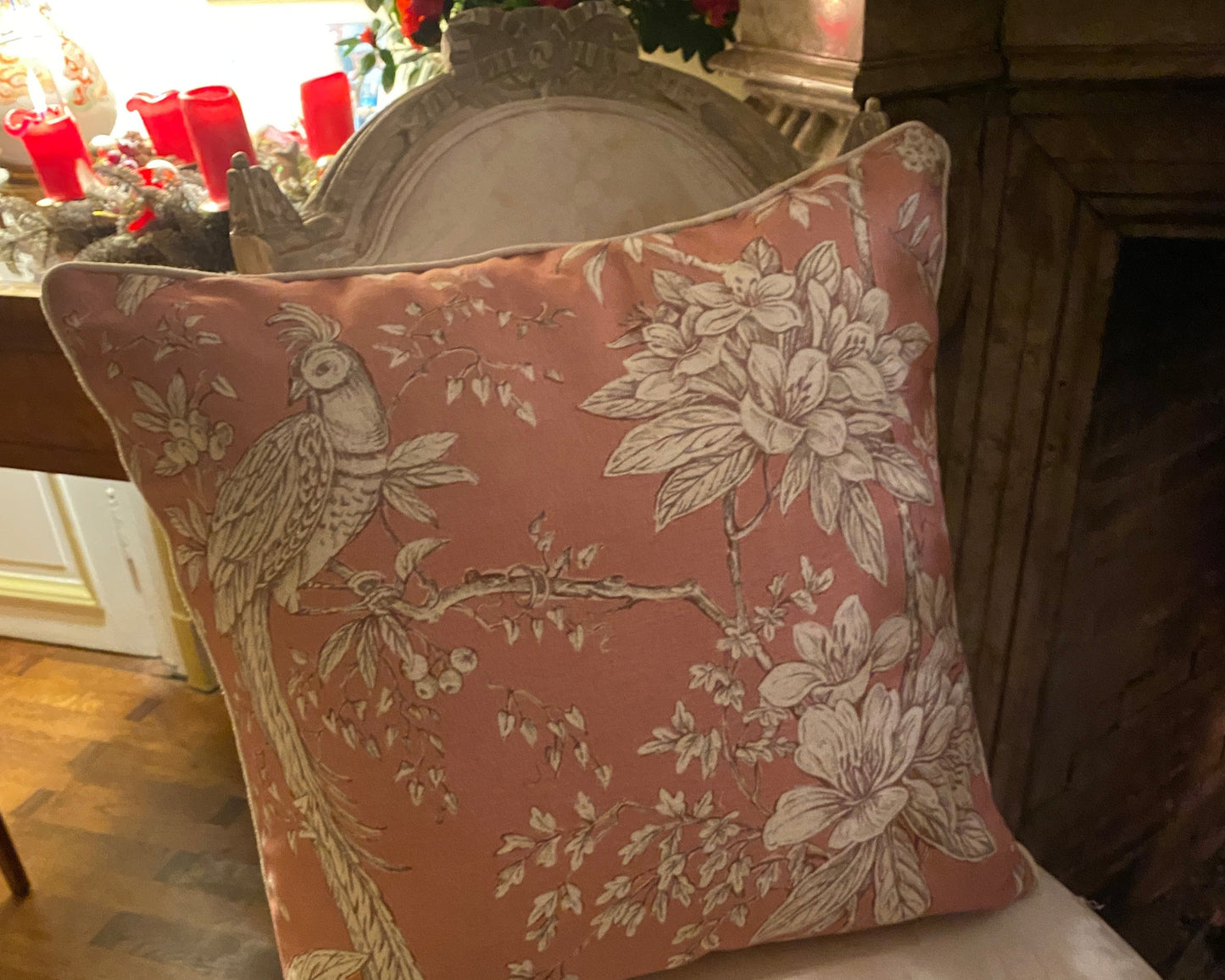 Decorative pink linen pillow with floral and bird pattern on a chair 50x50cm with piping ribbon