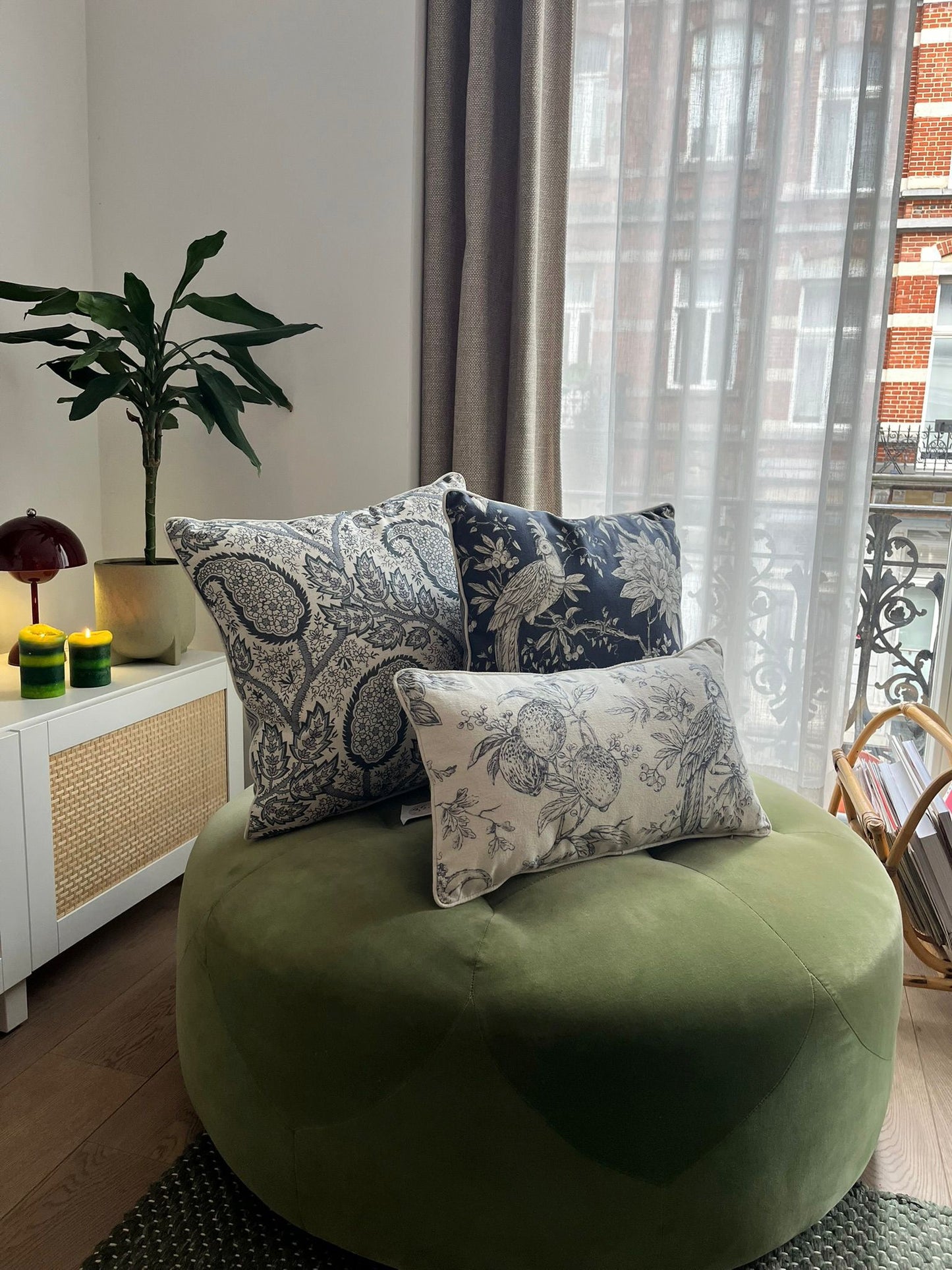 Blue-and-white patterned cushions on a classic armchair, blending modern flair with everyday comfort.