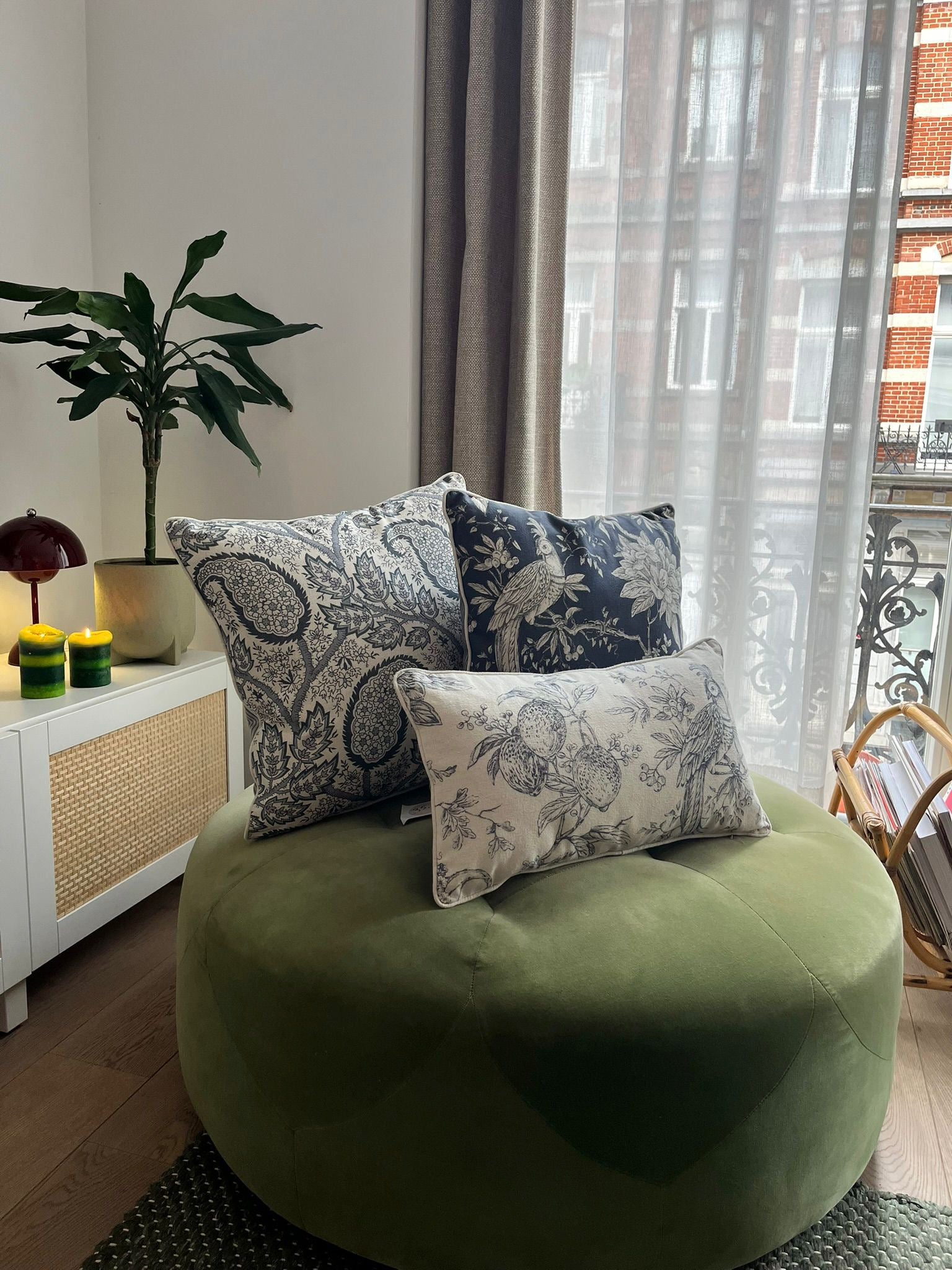 Blue-and-white patterned cushions on a classic armchair, blending modern flair with everyday comfort.