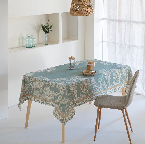 Table with a patterned tablecloth in a bright room
