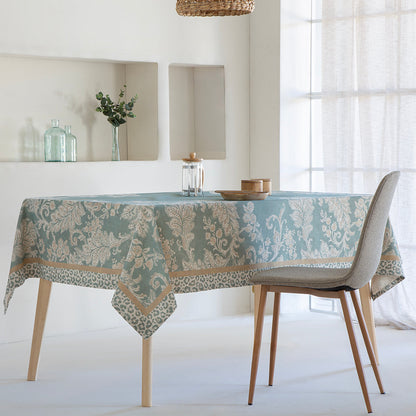 Dining table with a patterned tablecloth in a bright room