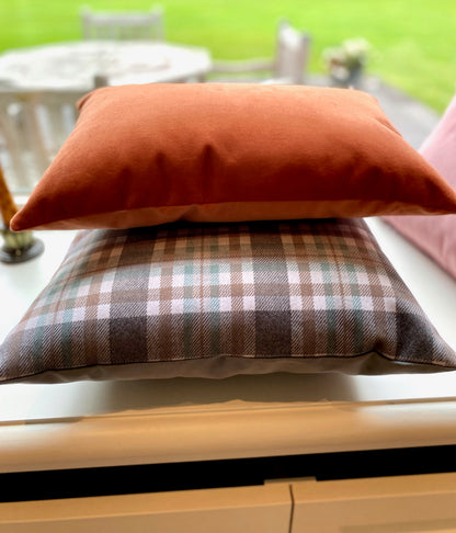 Stack of cushions on a surface with a blurred outdoor background