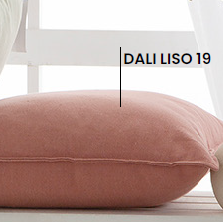  stonewashed linen Pink cushion  50x50 on a wooden surface with a white vase and blurred background