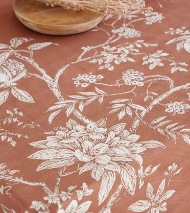 Floral pattern on a terracotta background with a wooden bowl.