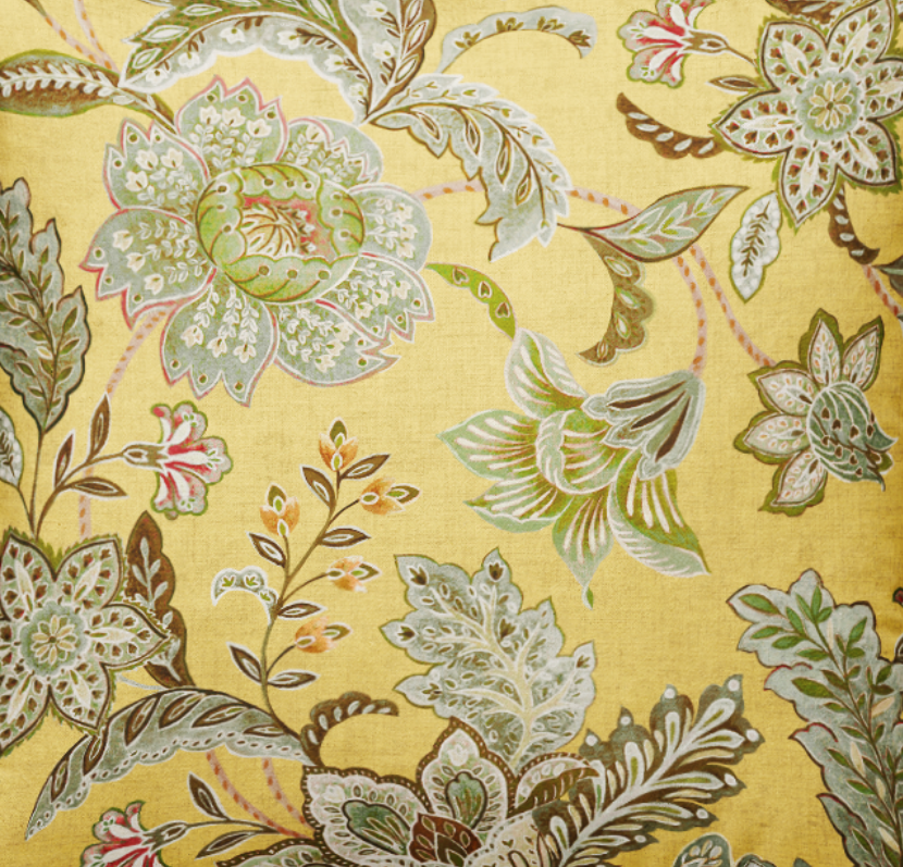 Decorative pillow with floral pattern on a yellow background